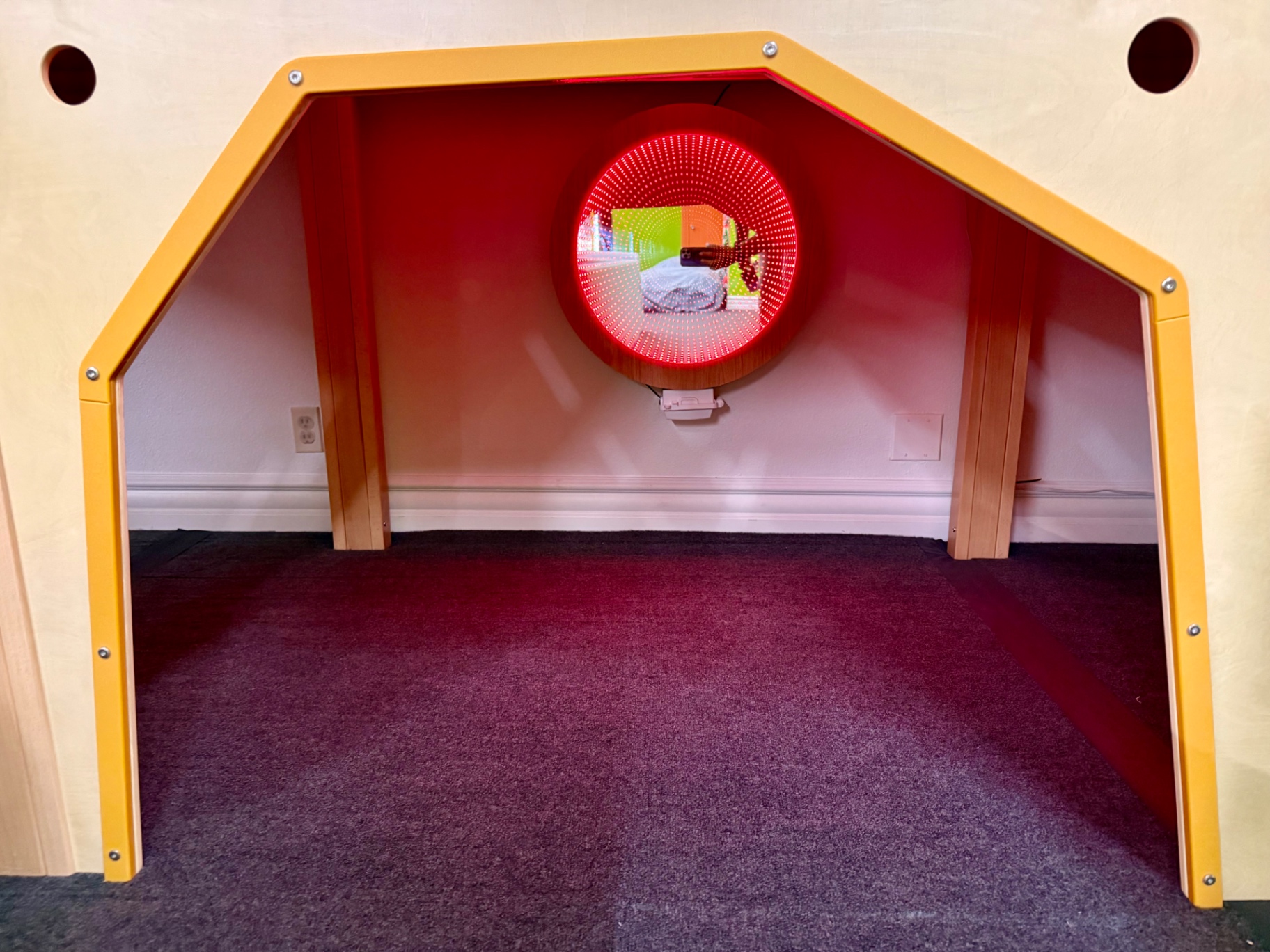 Orange sensory nook with red infinity mirror at Little Land Arcadia