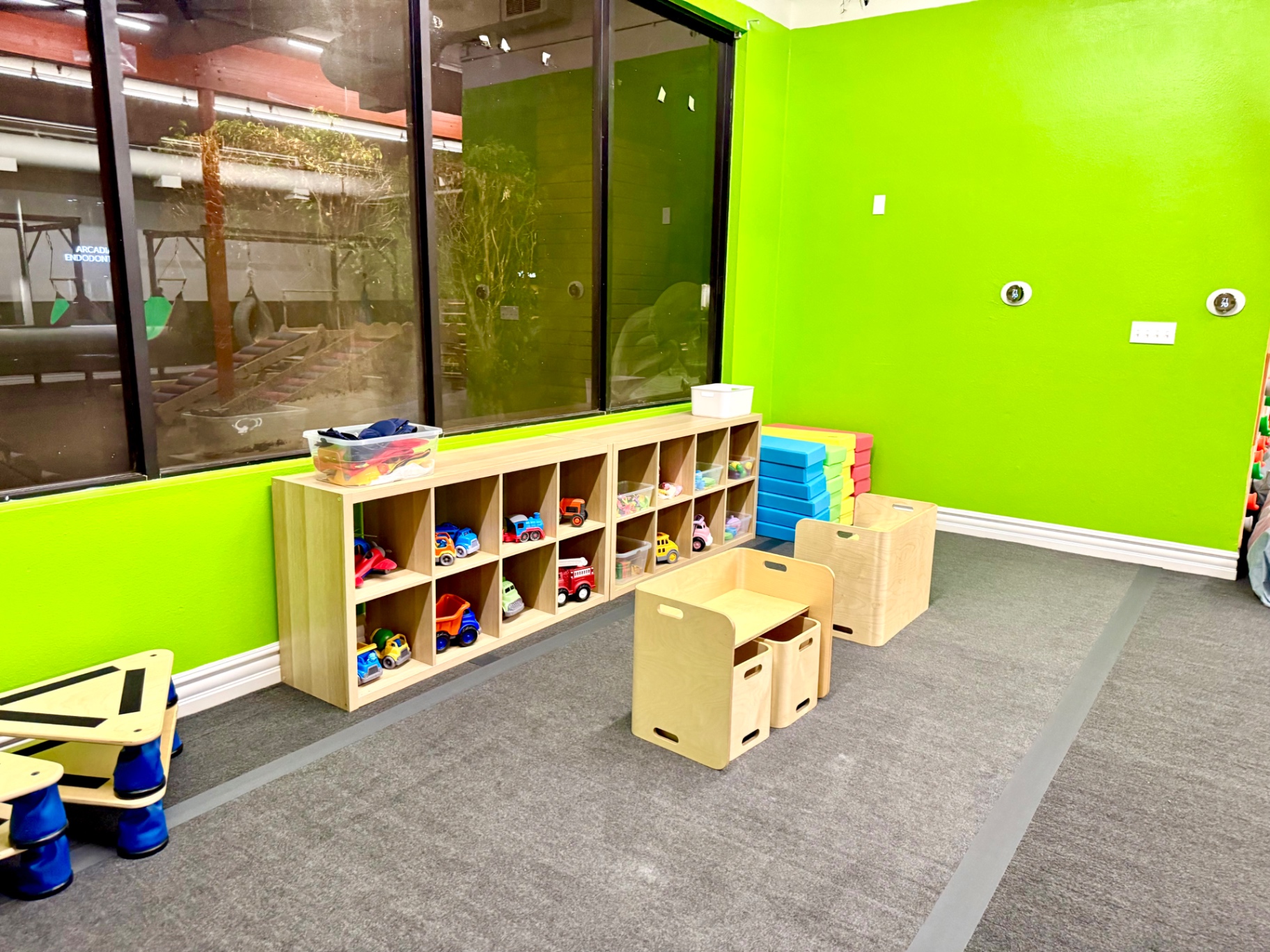Toy shelves stocked with cars and trucks in the Arcadia play area