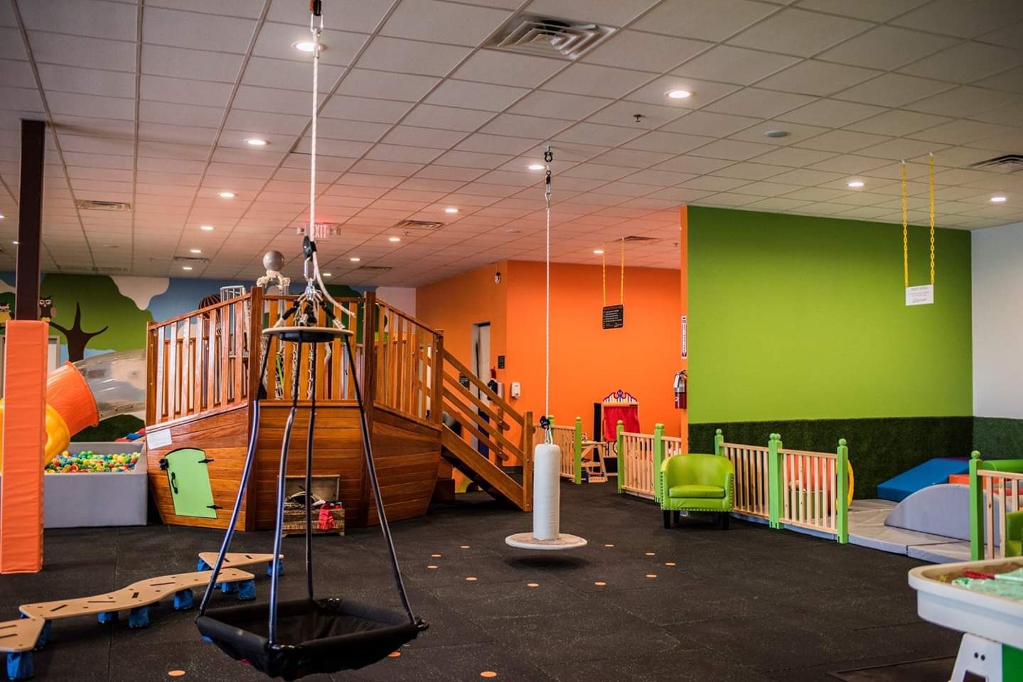 Santa Claus playing with two boys in the rainbow ball pit at Little Land Waco